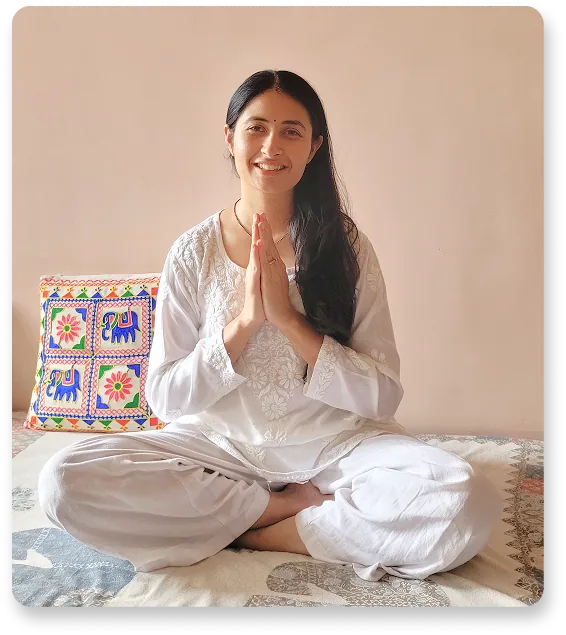 Harini seated cross-legged with her hands joined in Anjali Mudra