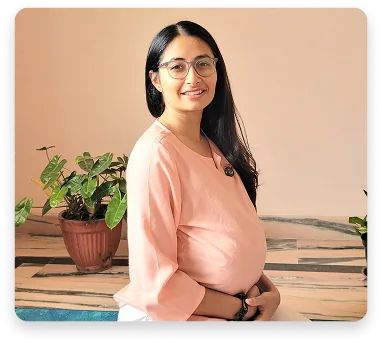 An expectant mother standing in a calm prenatal practice space